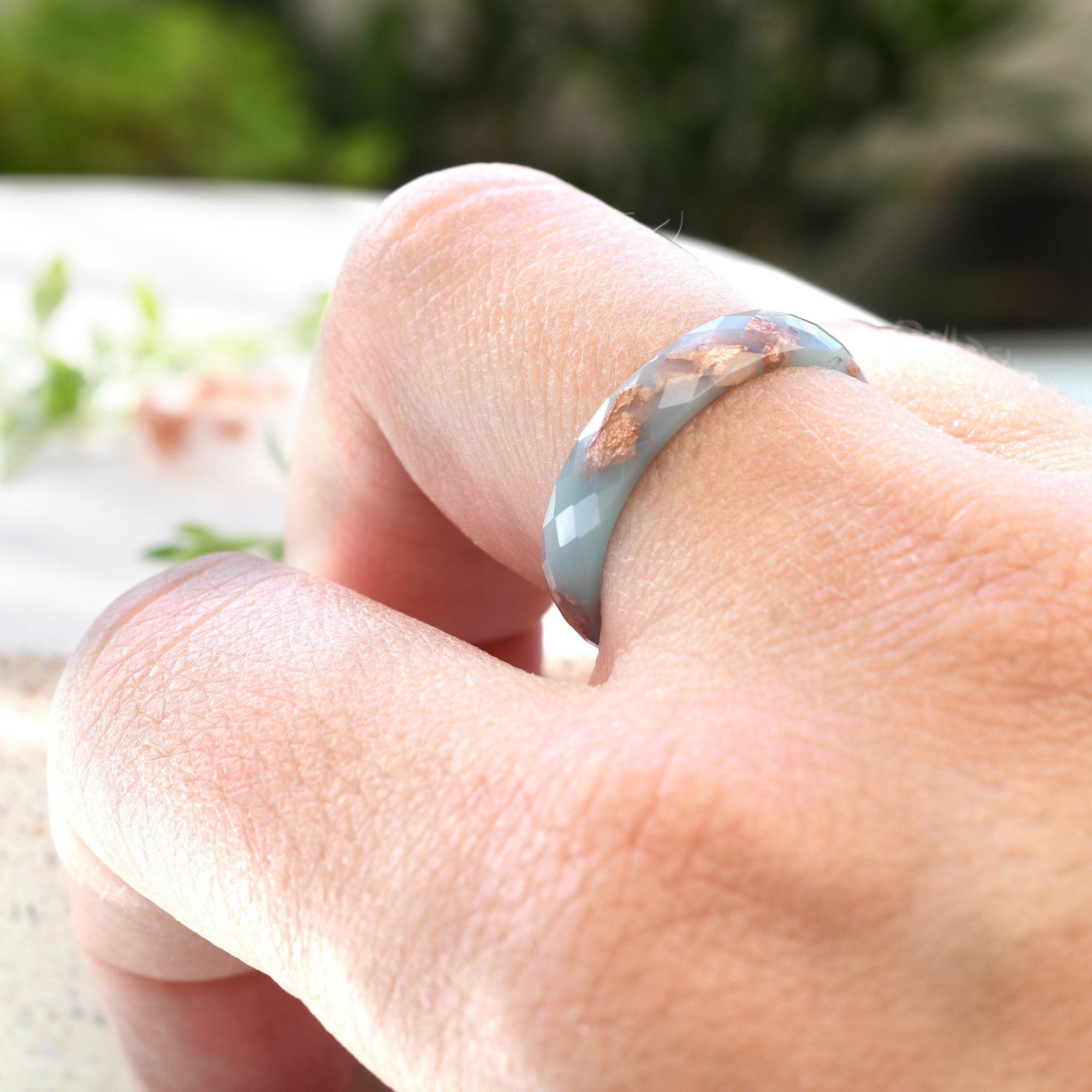 Handmade baby blue resin ring worn on hand — minimalist jewelry design