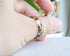 Transparent resin ring with mixed flakes worn on hand — unisex minimalist jewelry