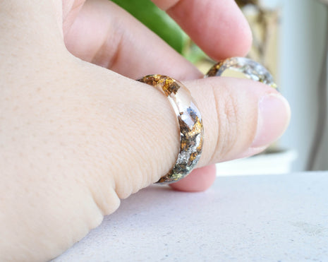 Transparent resin ring with mixed flakes worn on hand — unisex minimalist jewelry