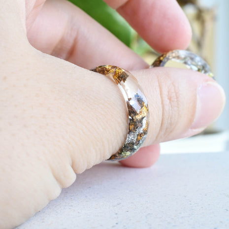 Transparent resin ring with mixed flakes worn on hand — unisex minimalist jewelry