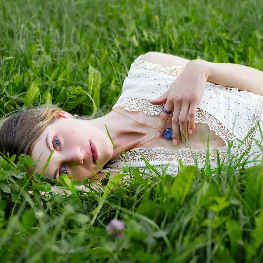 Handmade purple hydrangea resin necklace worn on model — botanical jewelry