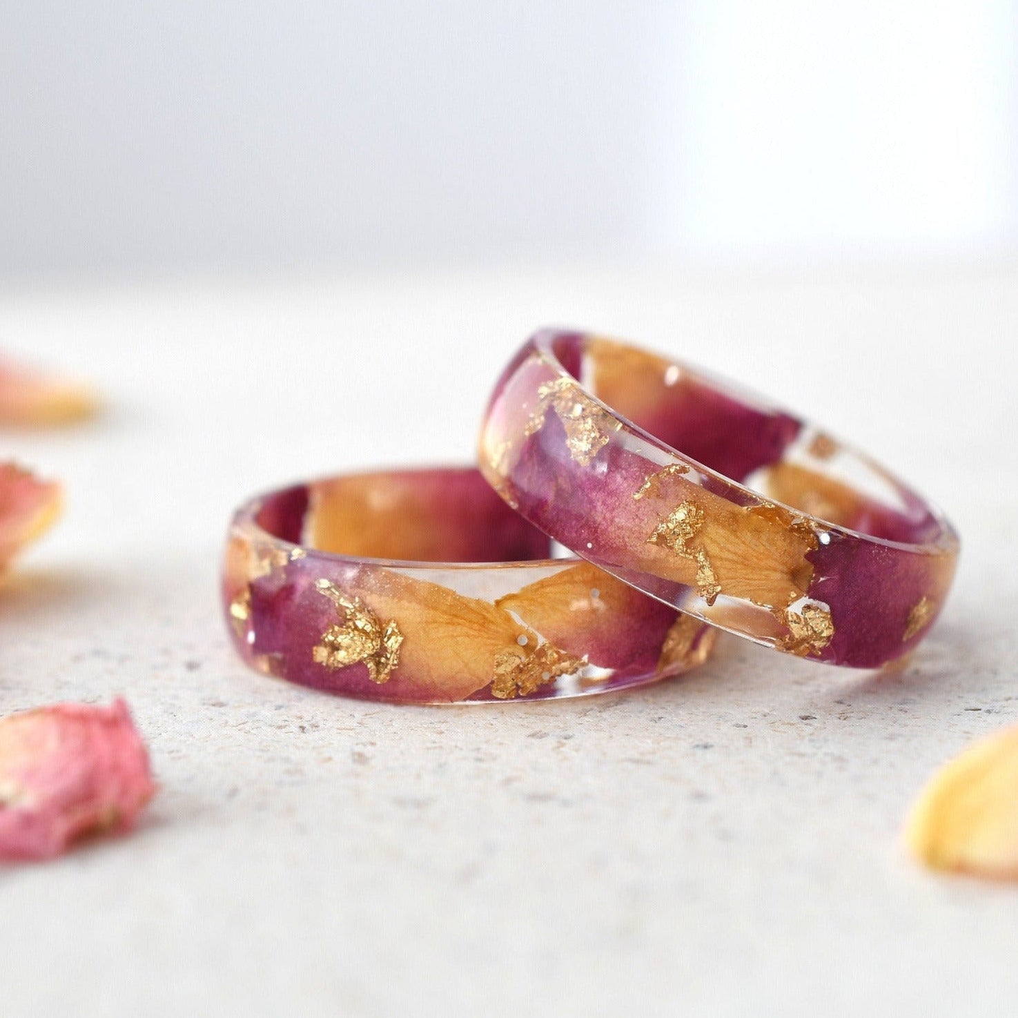 Close-up of Rose Bloom Ring highlighting dark pink rose petals and gold accents