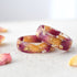 Close-up of Rose Bloom Ring highlighting dark pink rose petals and gold accents