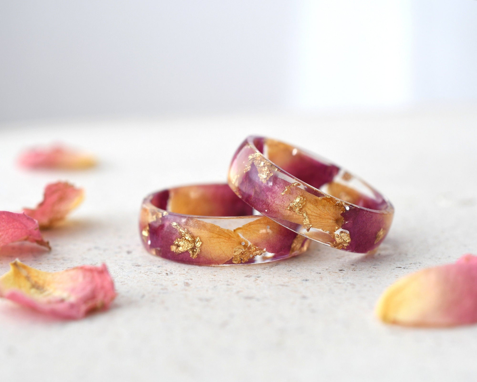 Close-up of Rose Bloom Ring highlighting dark pink rose petals and gold accents