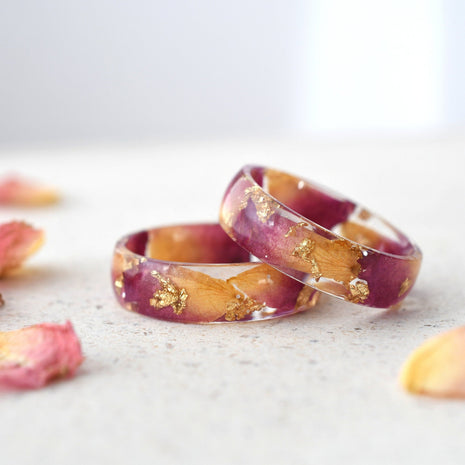 Close-up of Rose Bloom Ring highlighting dark pink rose petals and gold accents