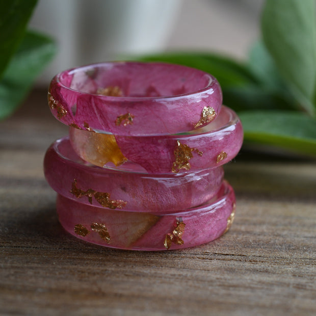close-up of pink rose petals inside clear resin with gold leaf