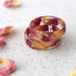 Side view showing smooth resin finish and embedded rose petals in Rose Bloom Ring