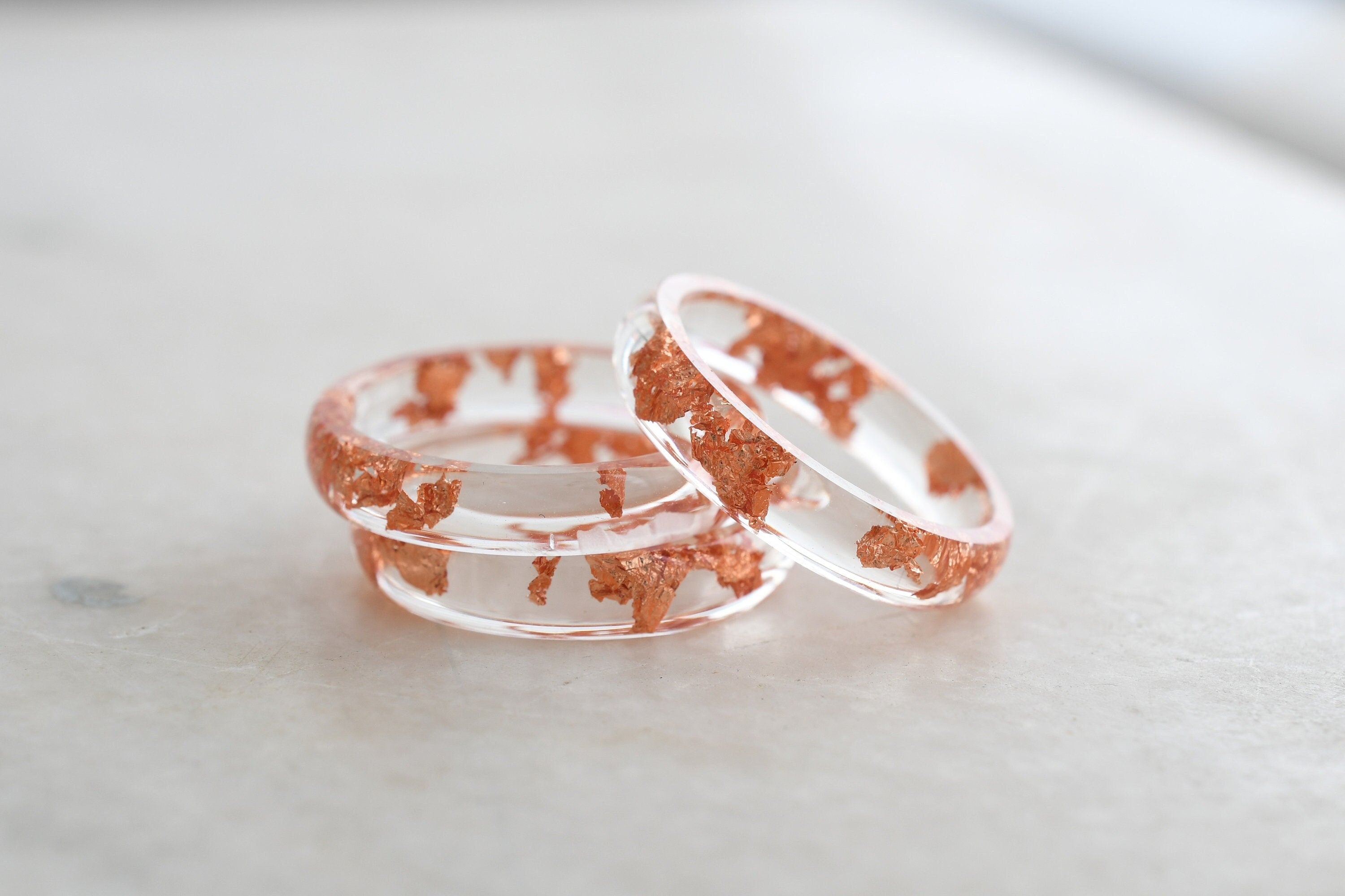 Transparent resin ring with rose gold flakes