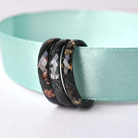 Flatlay of Shadowline Ring showing black resin with customizable metallic leaf shimmer