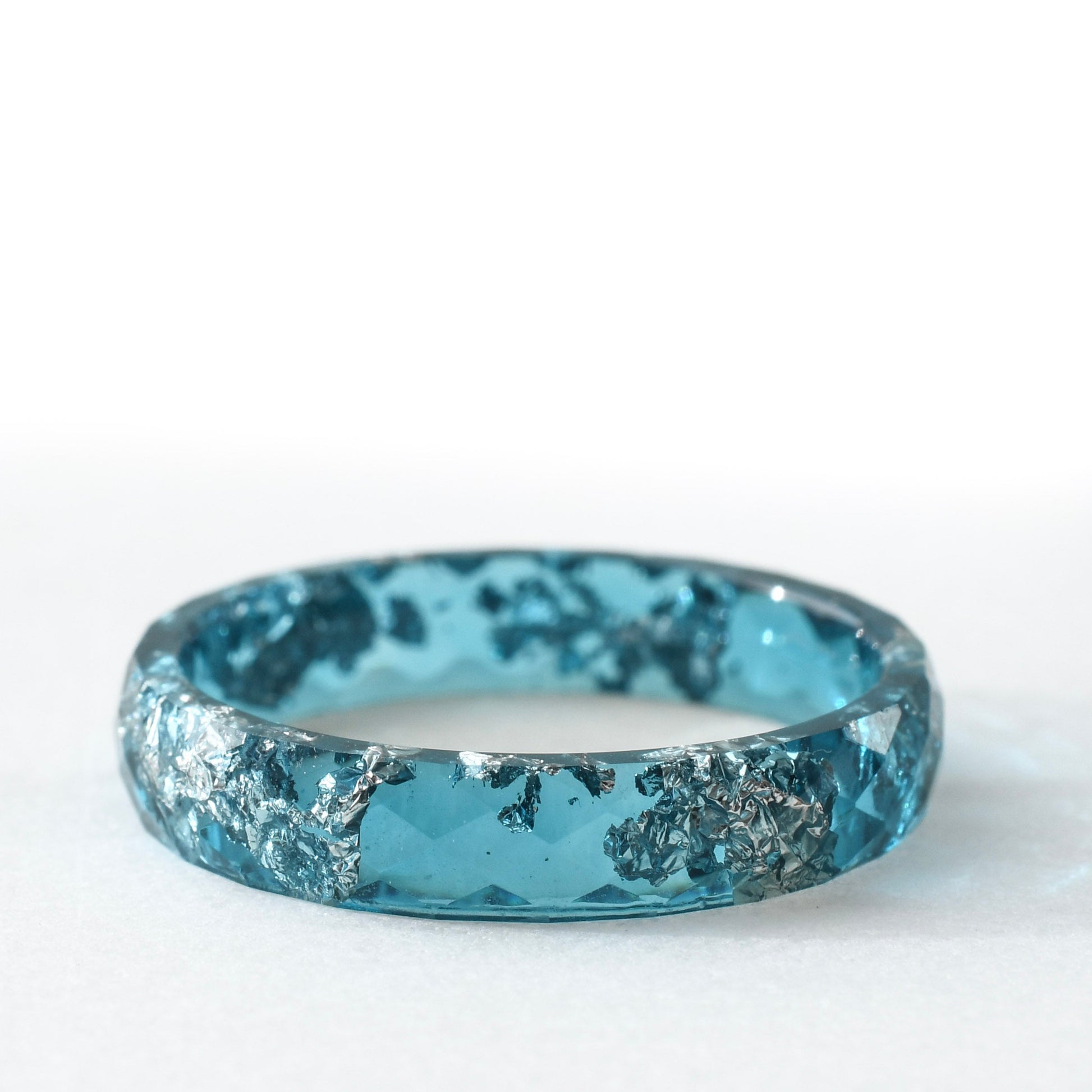 silver flakes resin ring stack in grey clear and blue tones close up