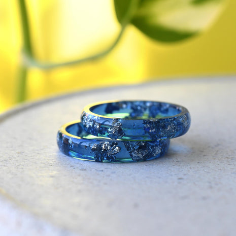 Close-up of real silver flakes in navy resin band