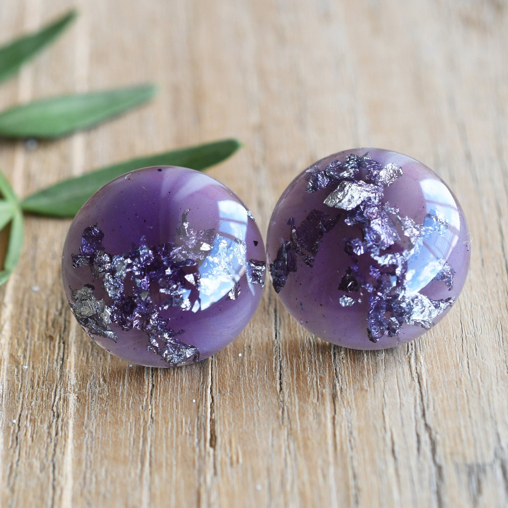 Close-up of silver flakes in lavender resin handmade earrings