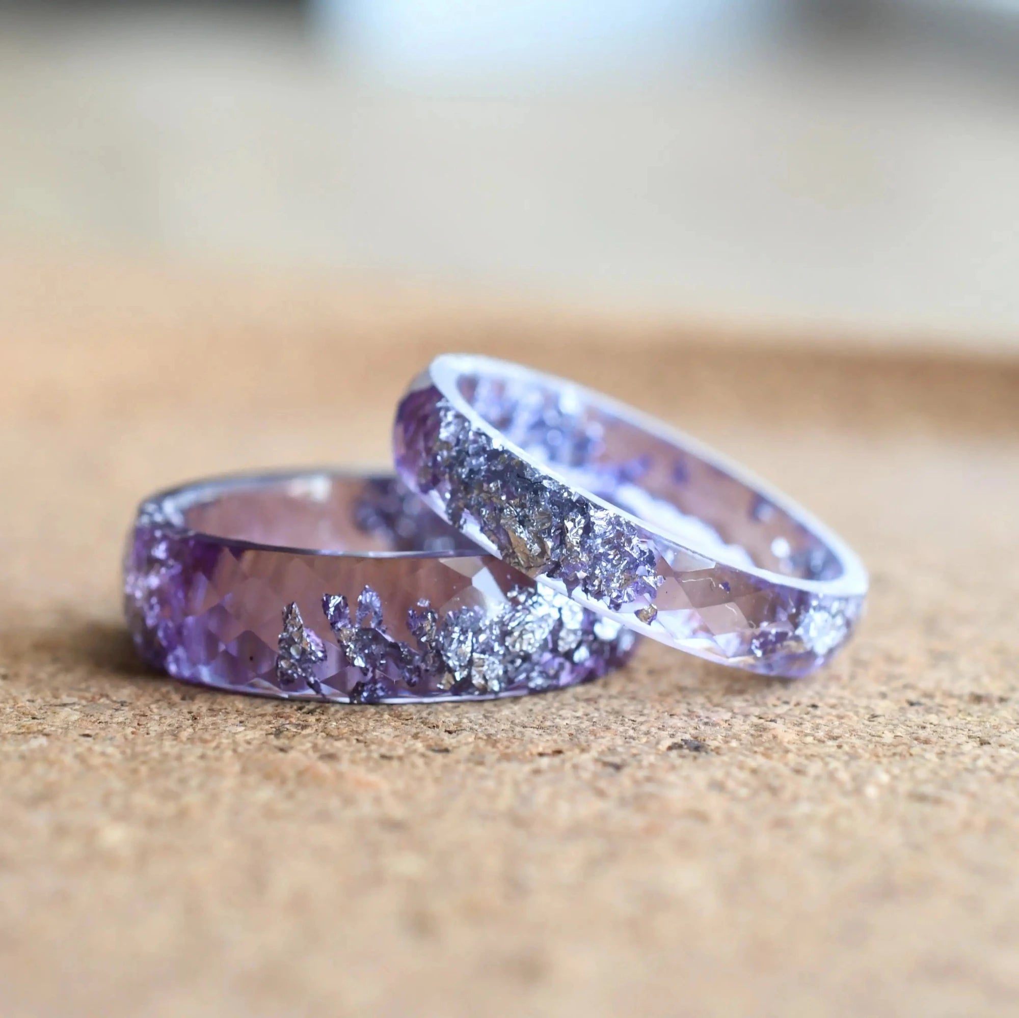Close-up of faceted lavender resin with silver leaf detail — handmade promise rings