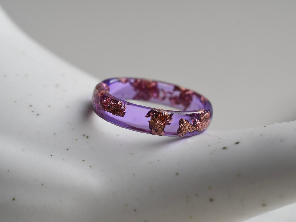 Slim purple resin ring with metallic rose gold flakes — handmade minimalist jewelry from Vienna
