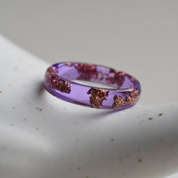 Slim purple resin ring with metallic rose gold flakes — handmade minimalist jewelry from Vienna