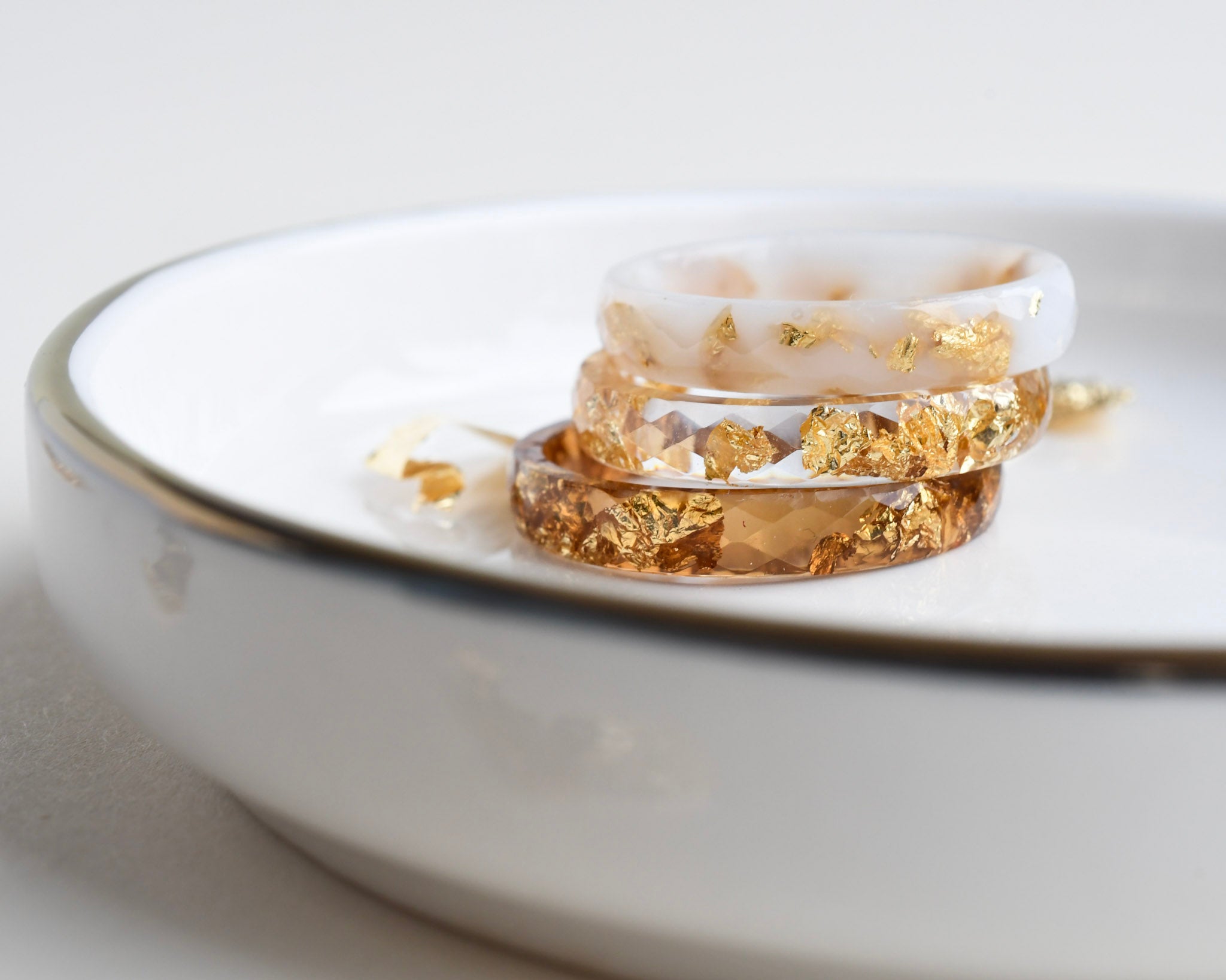 Slim resin ring set in white and clear resin with metallic gold flakes — modern handmade jewelry
