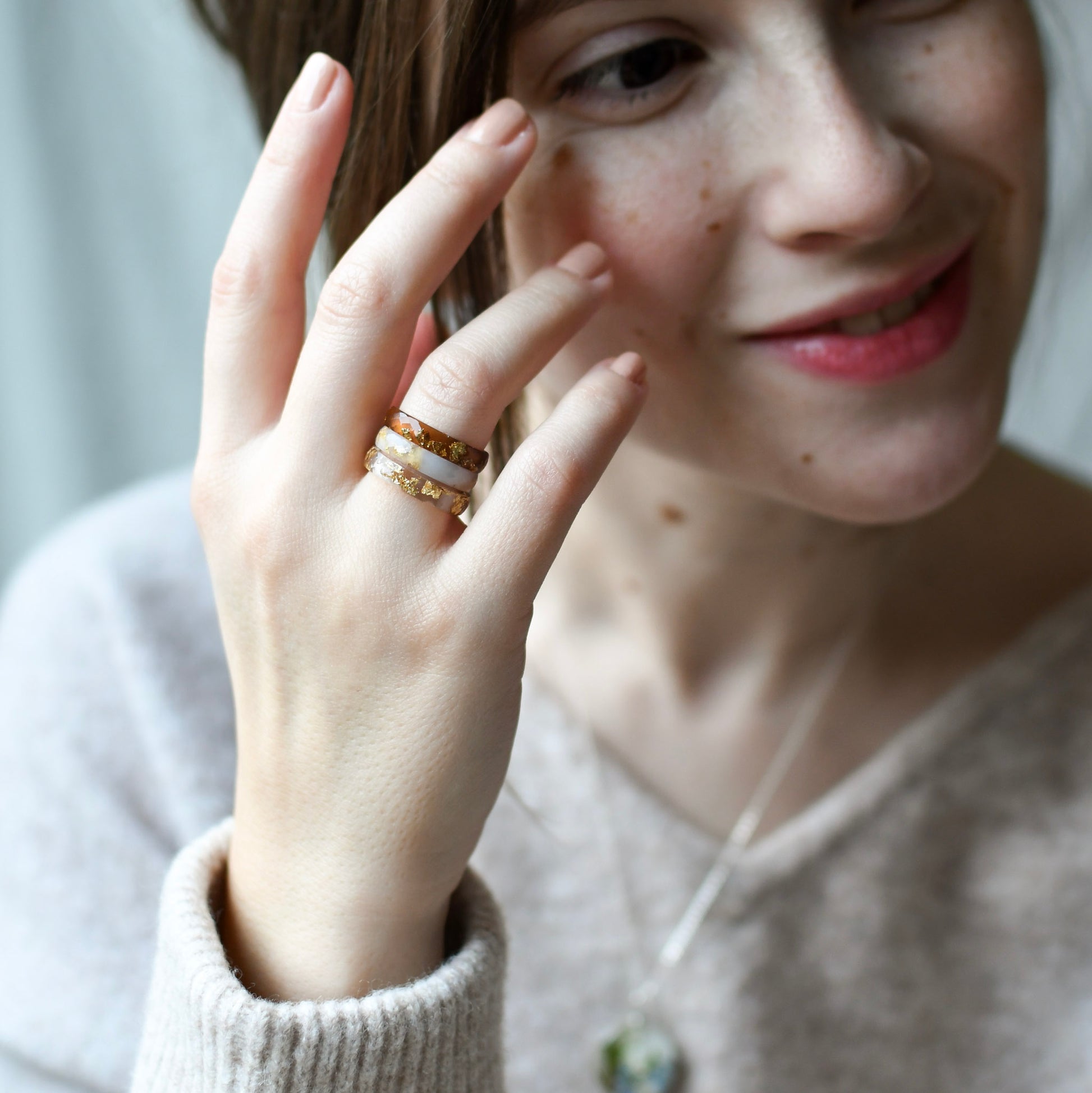Slim resin stacking rings worn on hand in a three ring stack