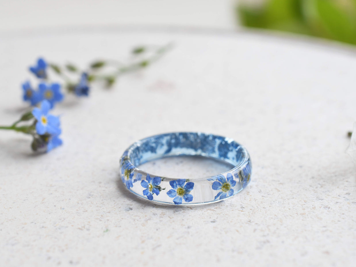 Smooth resin ring featuring real forget-me-nots, handmade jewelry