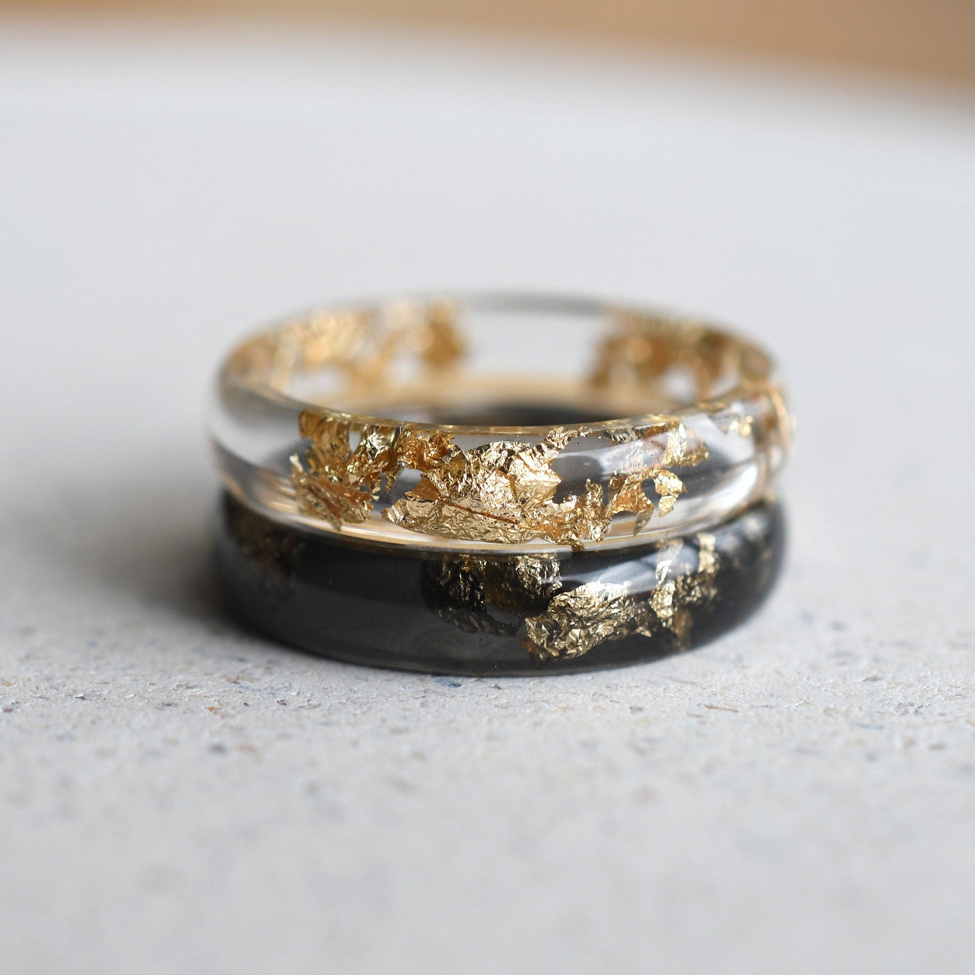 Smooth resin rings in transparent and black with gold leaf accents