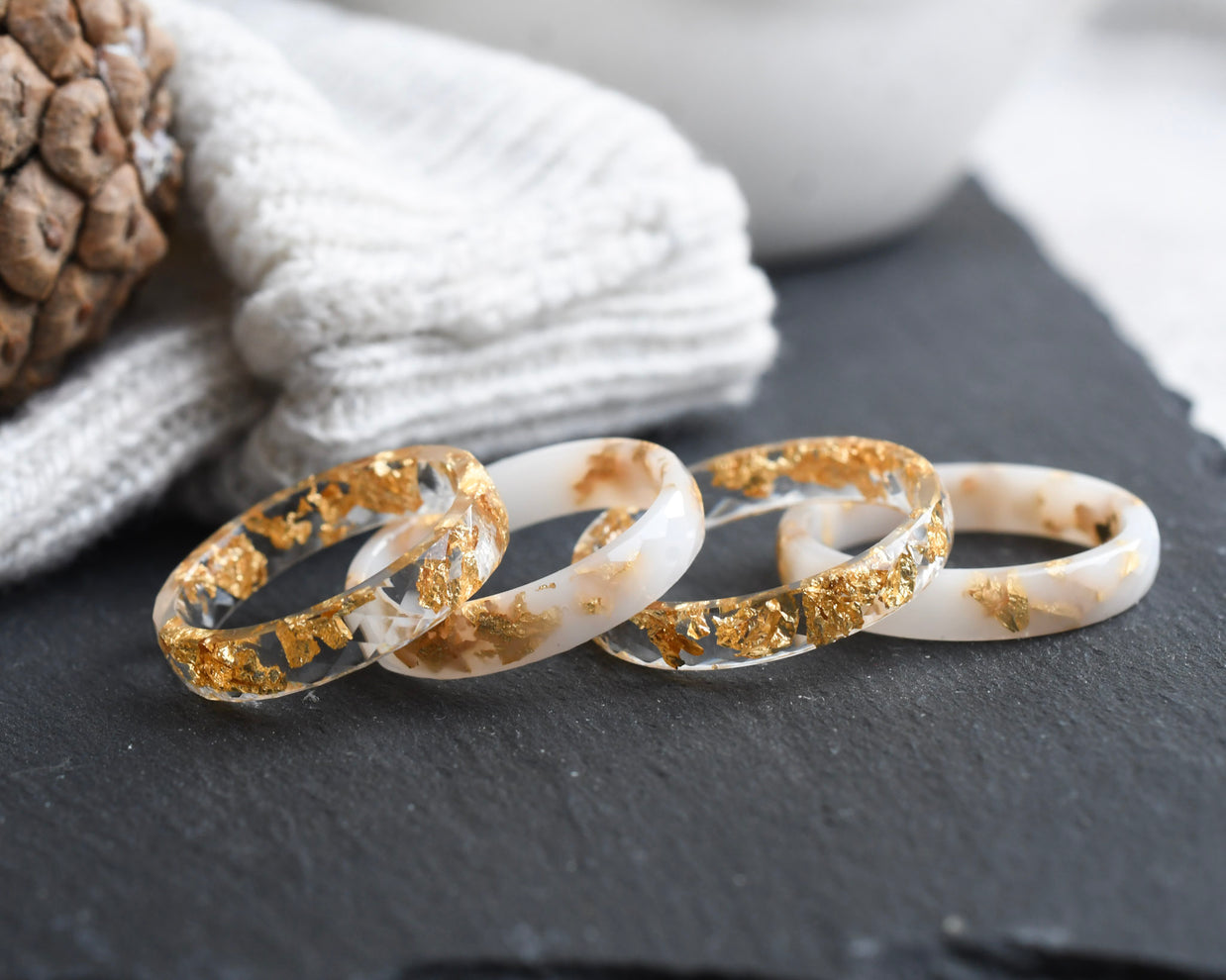 White and transparent faceted resin ring set with metallic gold flakes — handmade in Vienna by Resity