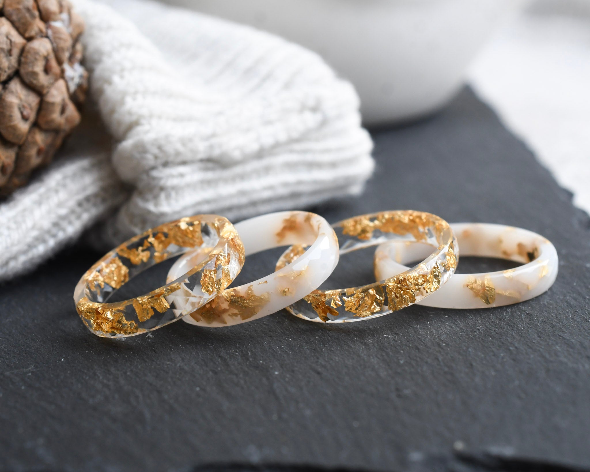 White and transparent faceted resin ring set with metallic gold flakes — handmade in Vienna by Resity