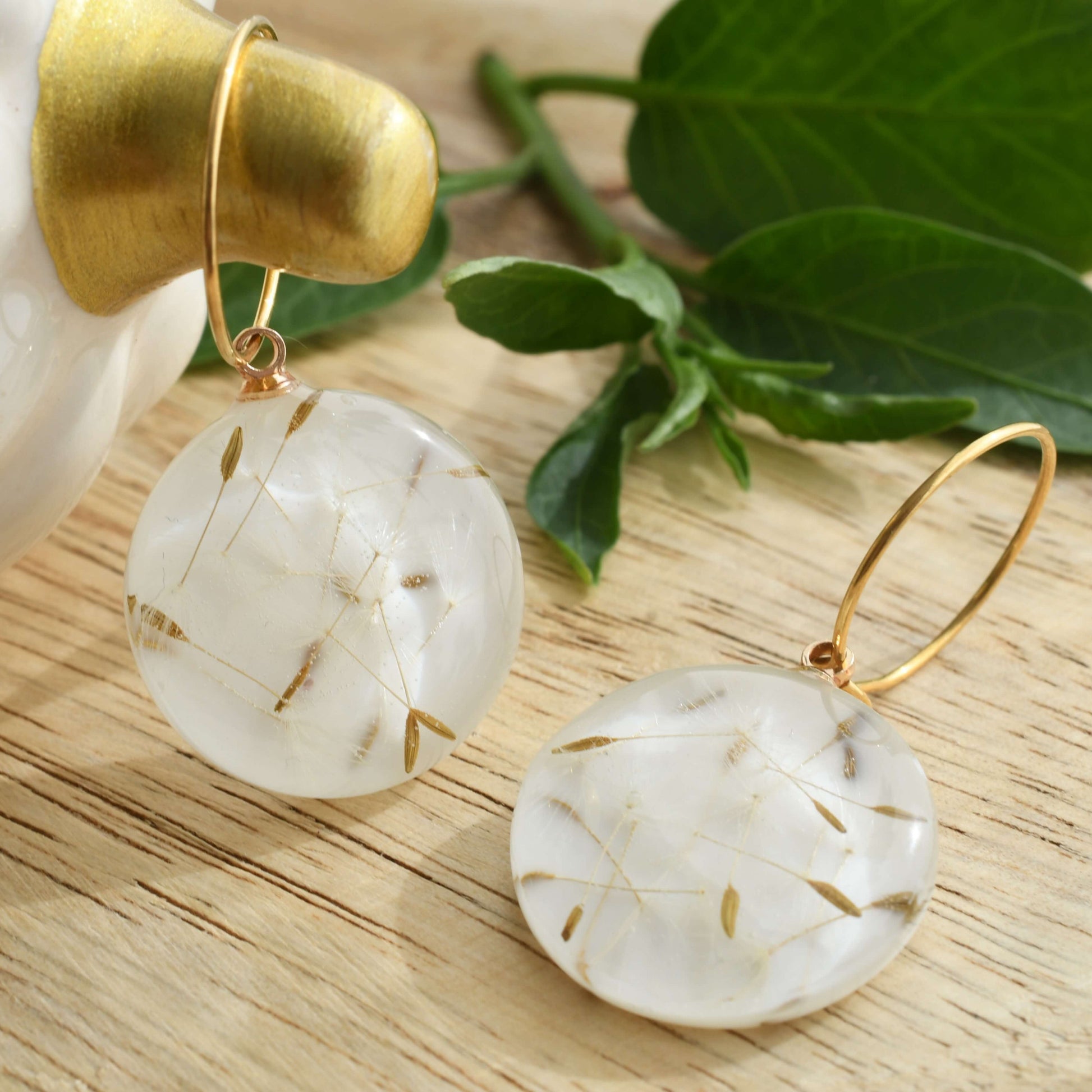 Gold filled hoop earrings with clear resin seed charms