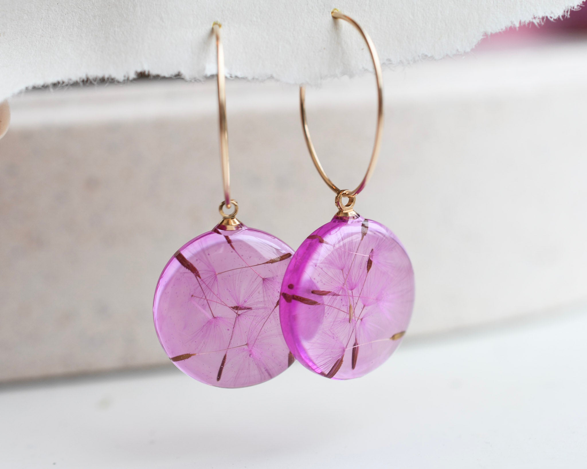 Real dandelion seed earrings in transparent pink resin