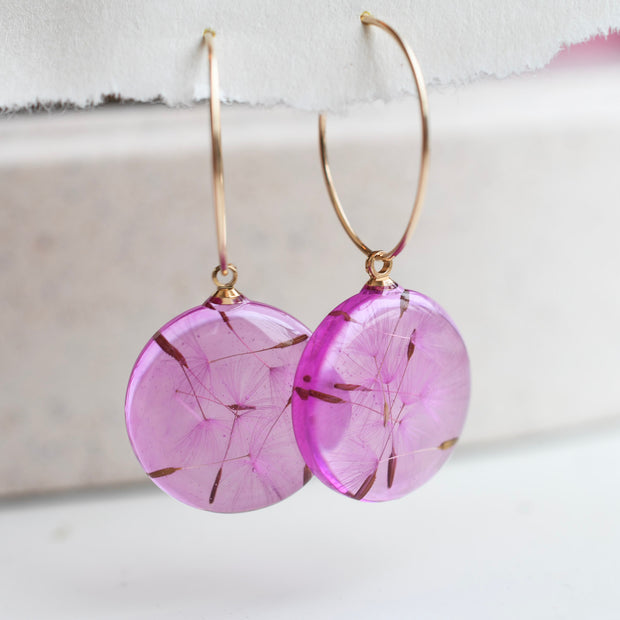 Real dandelion seed earrings in transparent pink resin