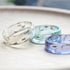 Trio of wish rings in lavender, blue, and clear resin