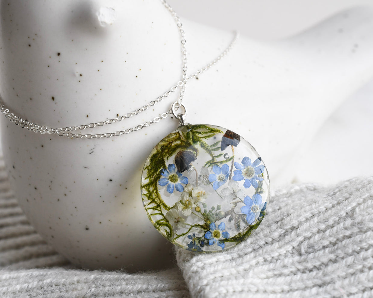 Woodland necklace with two tiny mushrooms, real moss, and flowers in a 25 mm terrarium pendant