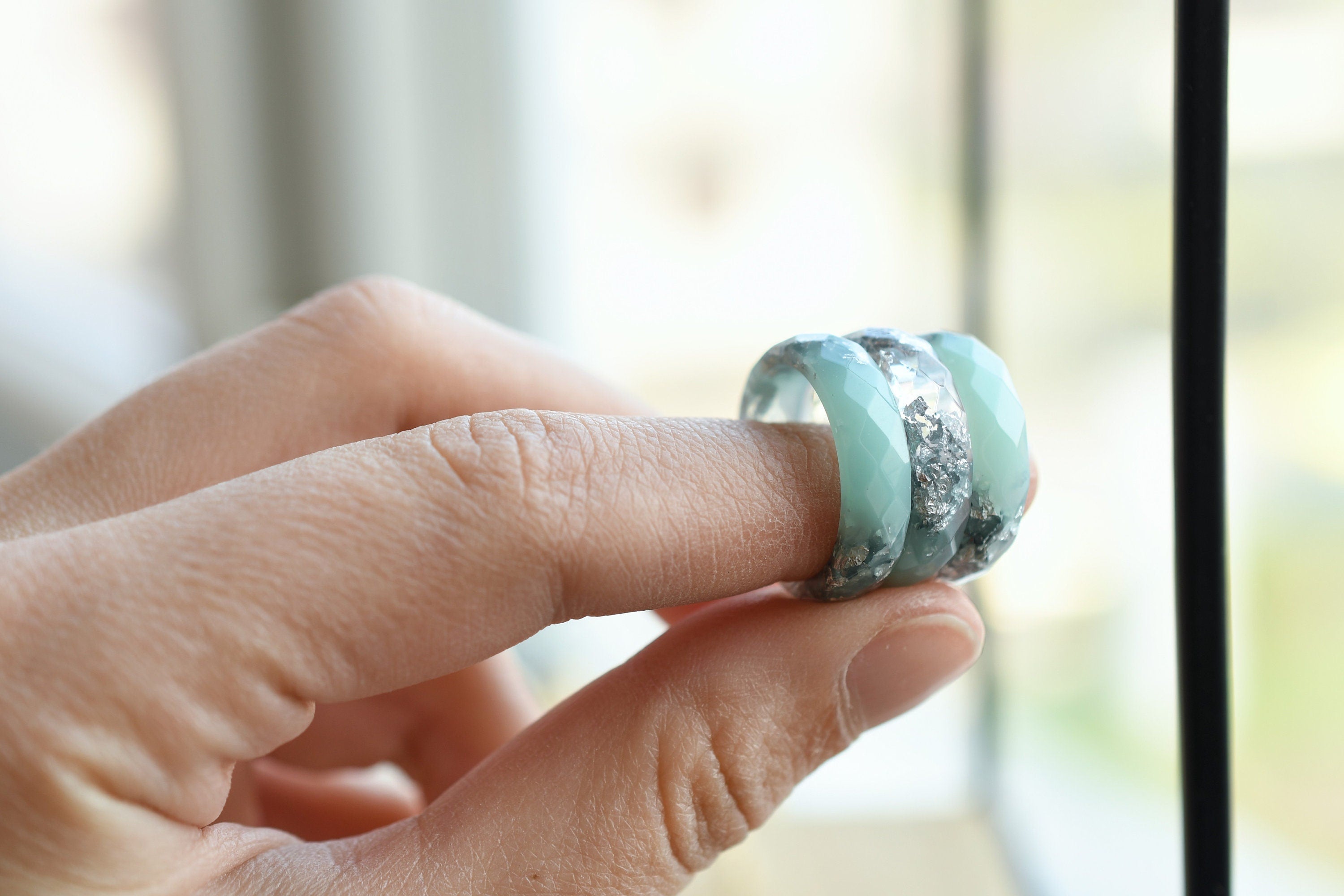 Silvermist Bloom Ring held in hand