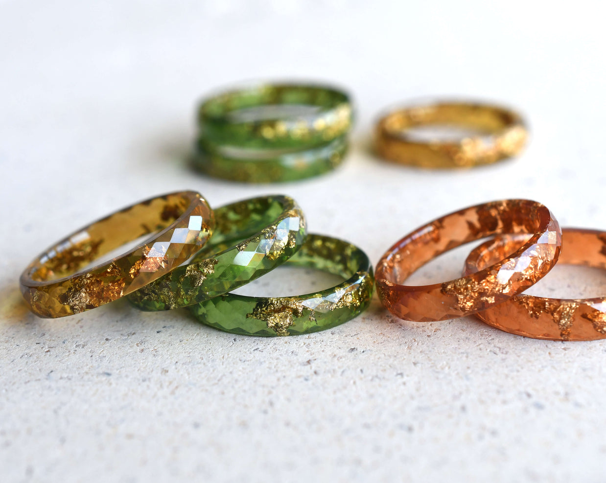 Amber Glow Ring — faceted amber resin rings with shimmering gold leaf detail