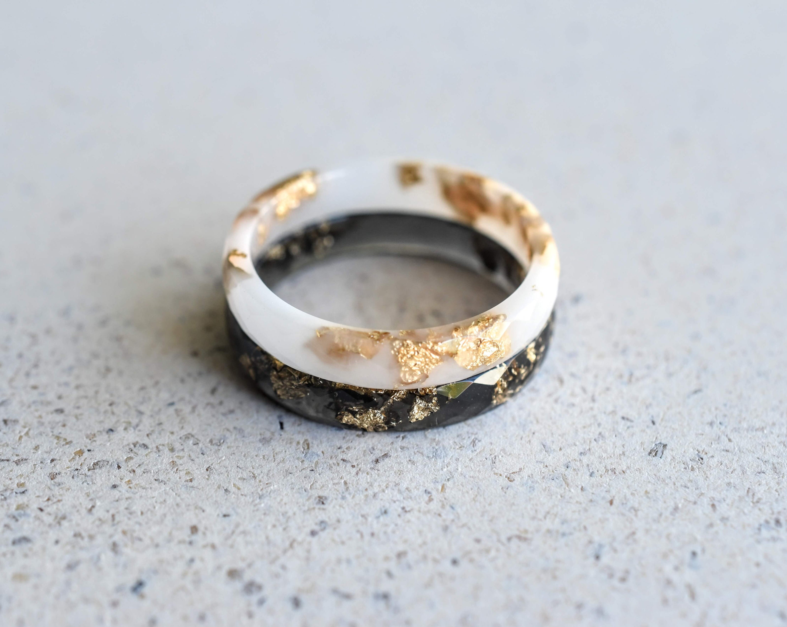 Handmade black and white resin rings with gold leaf — modern unisex jewelry crafted in Vienna by Resity