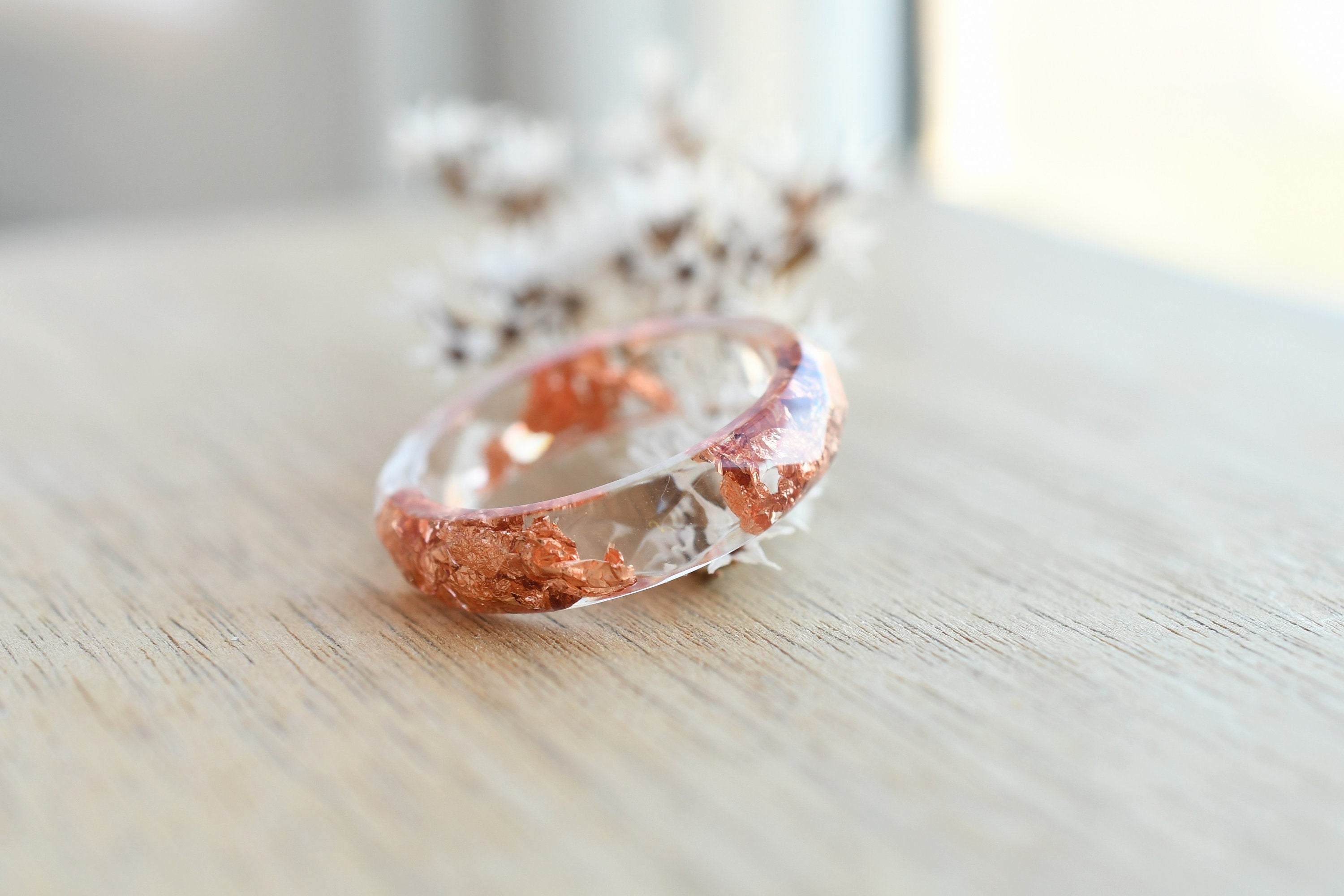 Close-up of metallic copper flakes in clear resin ring