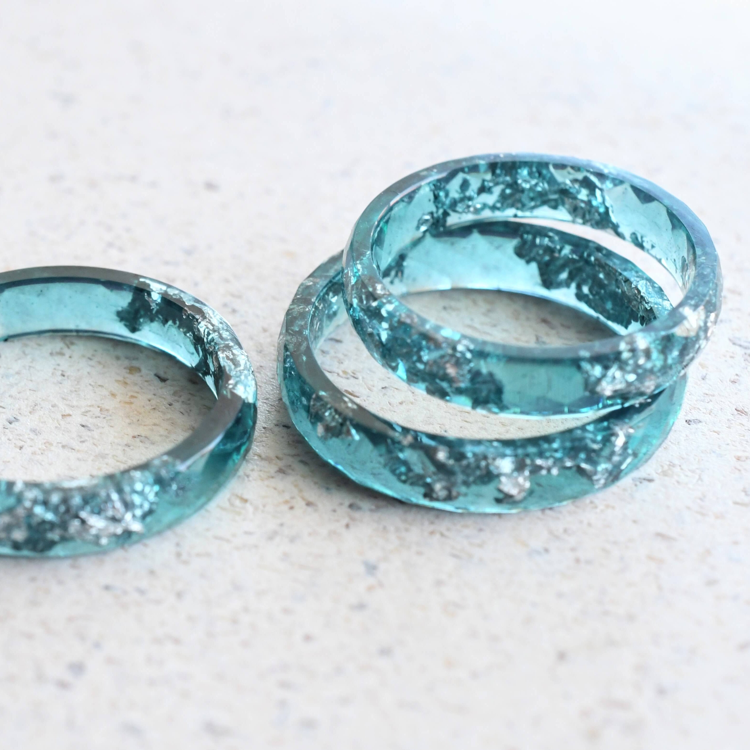 Close-up of emerald blue resin band with shimmering silver inside