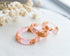 Close-up of gold flakes suspended in clear pink resin handmade ring