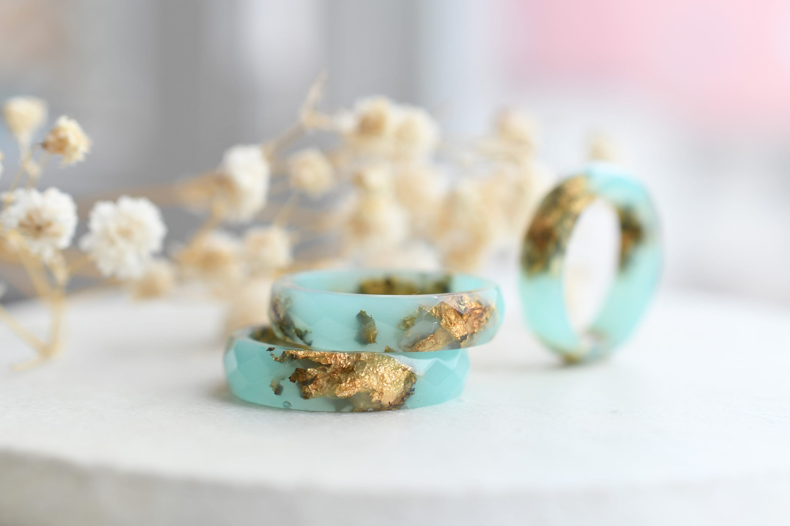 Close-up of gold flakes suspended in turquoise resin handmade ring