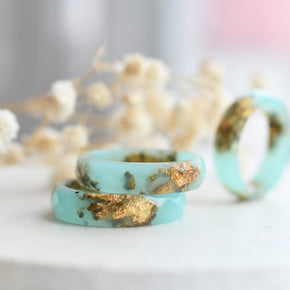 Close-up of gold flakes suspended in turquoise resin handmade ring