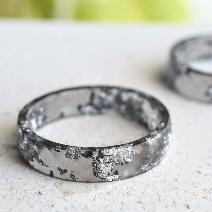 Flatlay of Charcoal Silver Leaf Ring showing silver flakes in dark resin