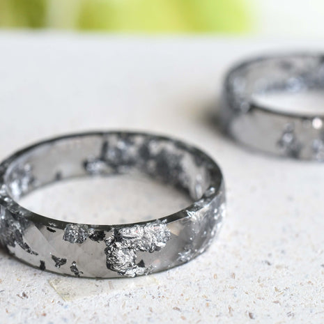 Flatlay of Charcoal Silver Leaf Ring showing silver flakes in dark resin