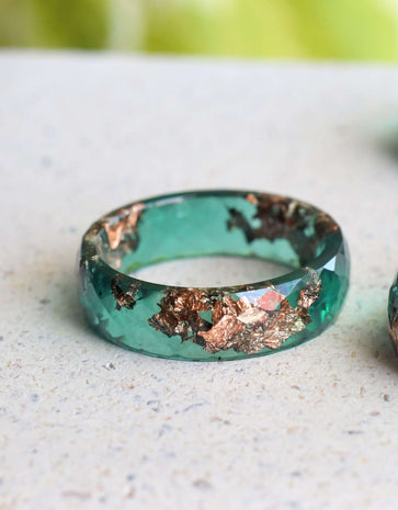 Jade resin ring with rose gold leaf on white background