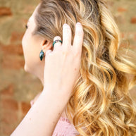 Stackable green resin ring with rose gold flakes on model hand