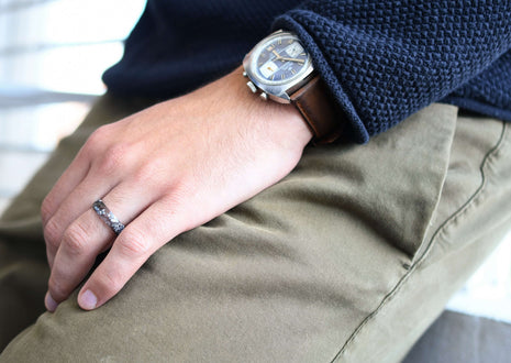 Close-up of ring with shimmering silver leaf in charcoal pigmented resin