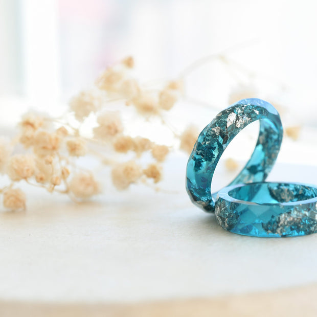 Flatlay of Ocean Signal Ring showing silver flakes in teal resin