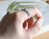 White resin ring with silver flakes worn on hand — unisex minimalist jewelry