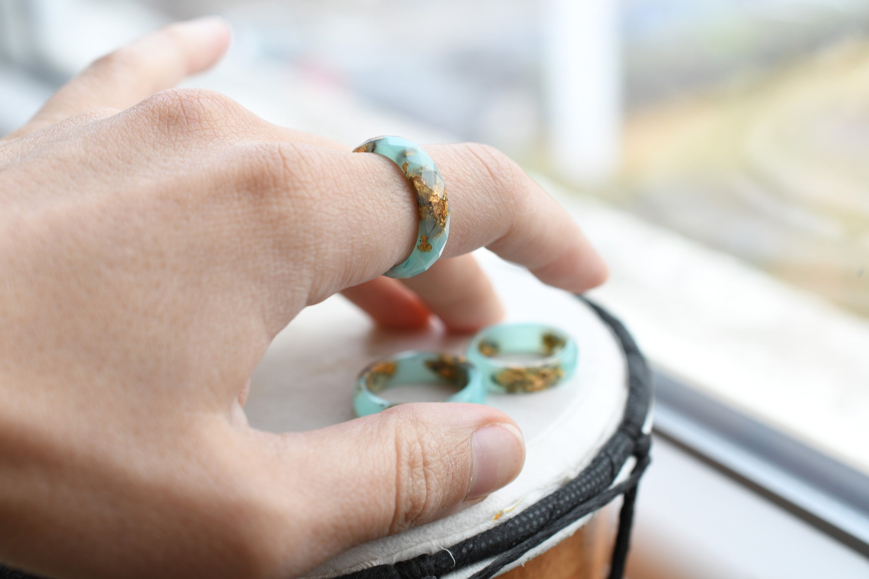 Turquoise resin ring with gold flakes worn on hand — unisex minimalist jewelry