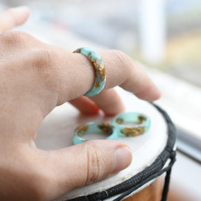 Turquoise resin ring with gold flakes worn on hand — unisex minimalist jewelry