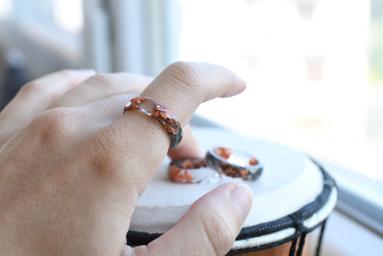 Grey and transparent resin ring worn on hand — minimalist unisex jewelry