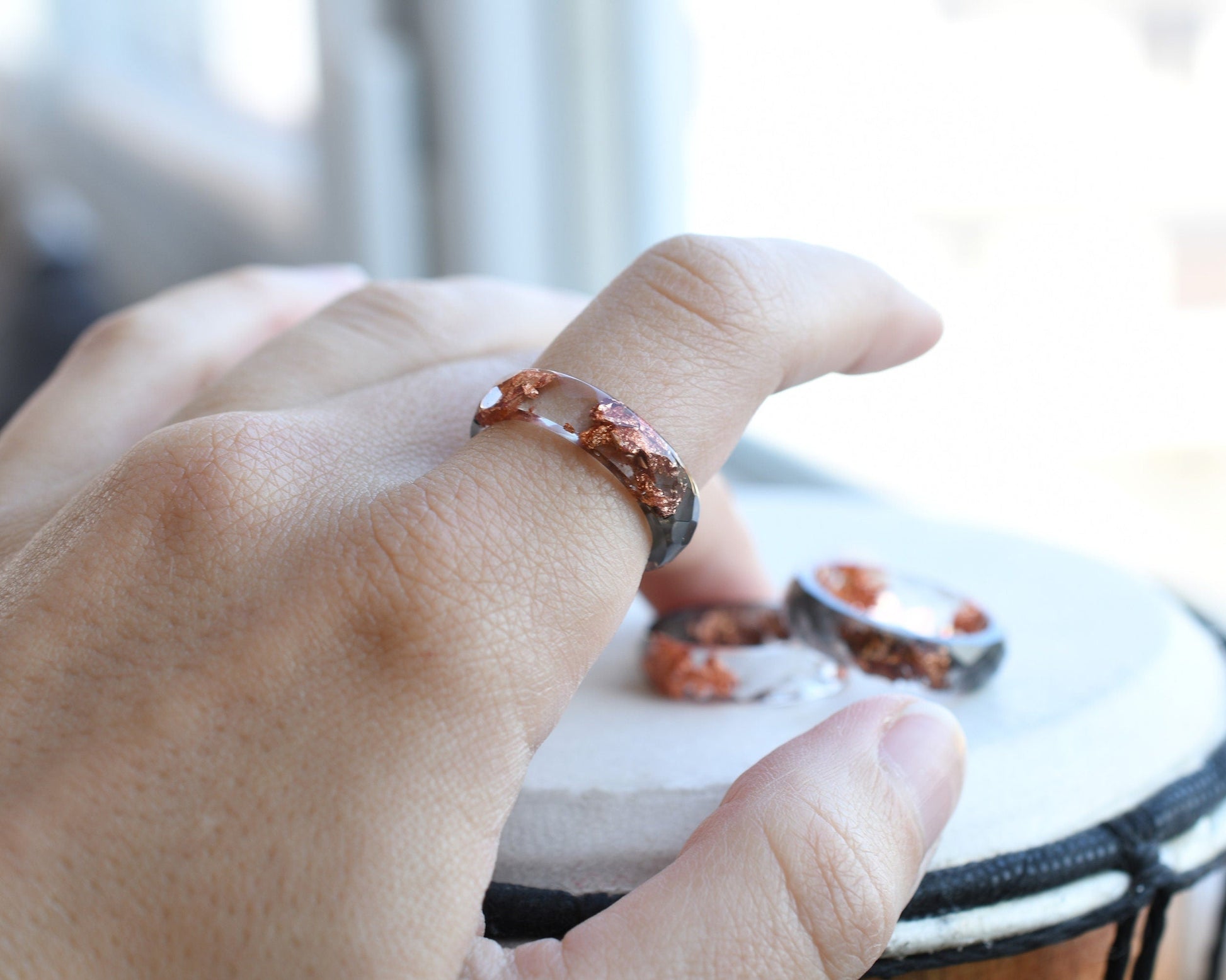 Grey and transparent resin ring worn on hand — minimalist unisex jewelry