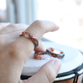 Grey and transparent resin ring worn on hand — minimalist unisex jewelry